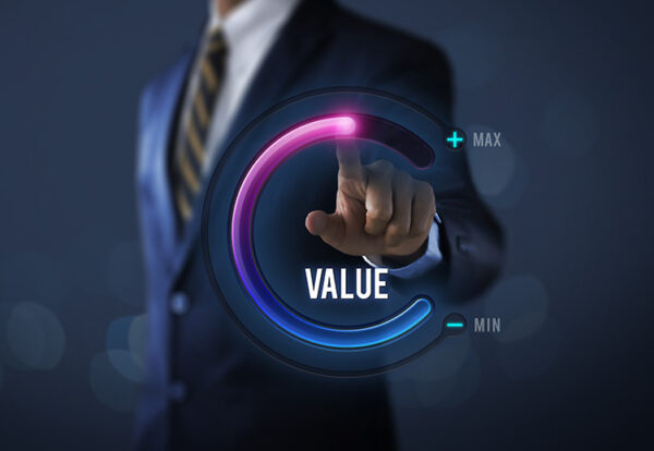 Growth value, increase value, value added or business growth concept. Businessman is pulling up circle progress bar with the word VALUE on dark tone background.